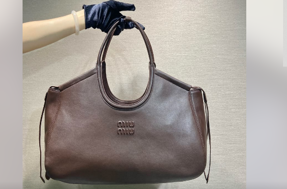 Brown soft leather hobo tote bag with oval handles and embossed logo